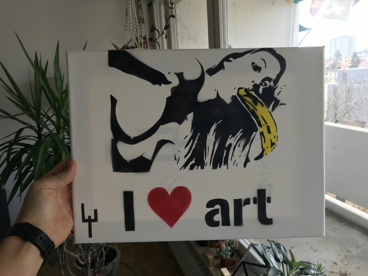 Canvas with stencil graffiti depicting a woman sucking on a banana and the text I heart art underneath