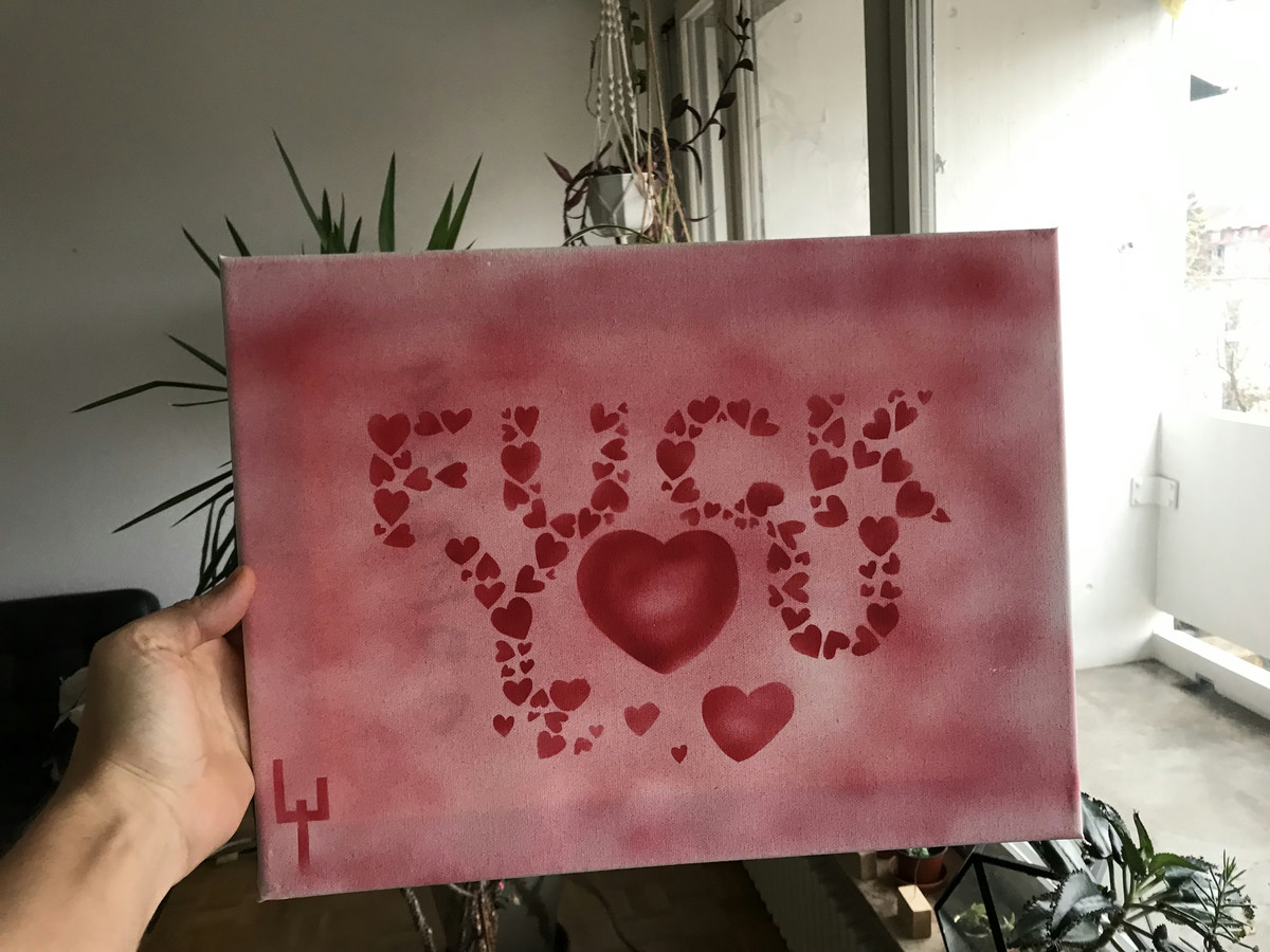 Canvas stencil graffiti depicting small red hearts forming the words FUCK YOU